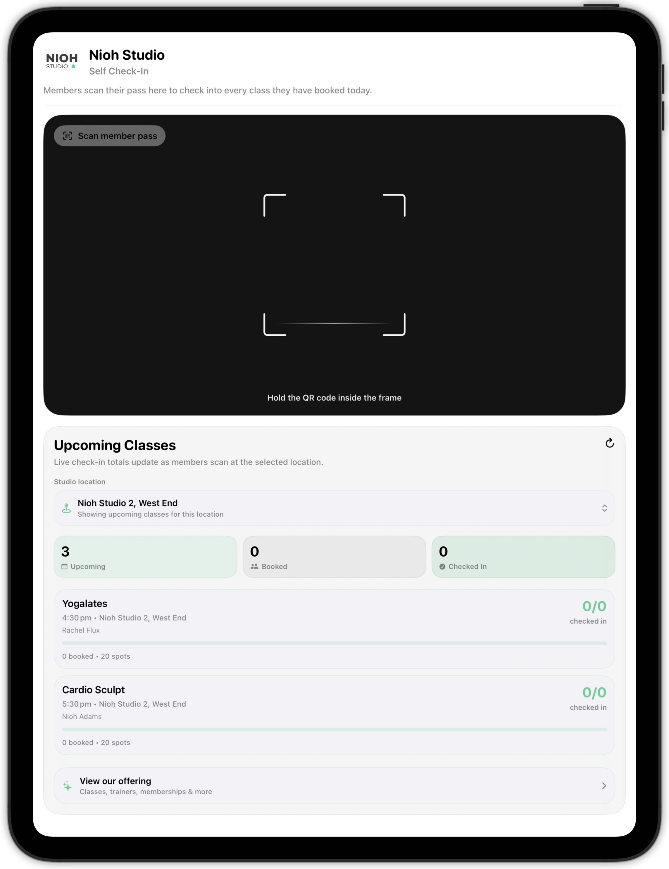 The self-serve kiosk on an iPad held in portrait, with the scanner across the top and the Upcoming Classes panel and its check-in totals stacked beneath it