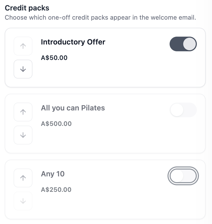 The Credit packs section of the Welcome email settings, with each pack and its price beside a show-or-hide switch and up and down arrows for reordering