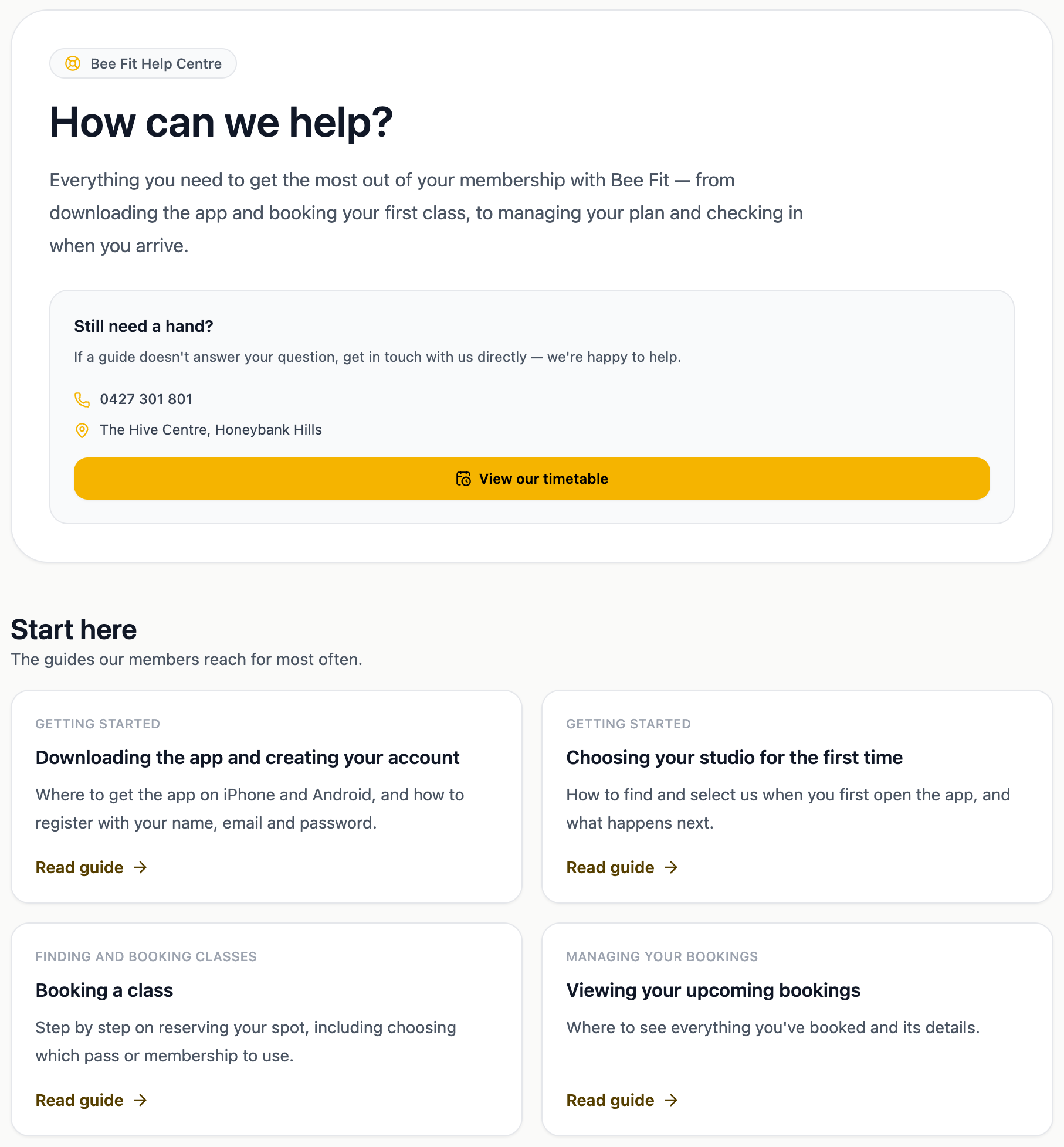 The top of a studio's member help centre, with the studio's own name and colours, a Still need a hand card carrying its phone number, address and a View our timetable button, and a Start here panel of the most-used guides
